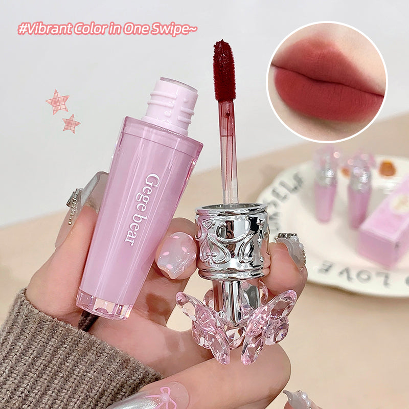 Pink lip gloss with silver cap held by a hand, close-up of lips with color swatch.