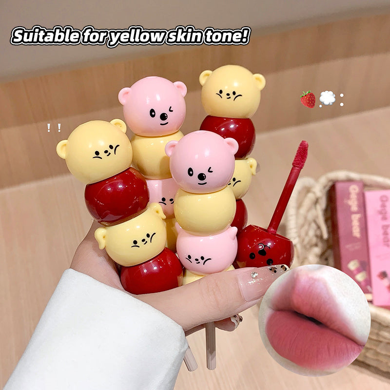 Colorful lip balm sticks with cartoon characters held by a hand, suitable for yellow skin tone.