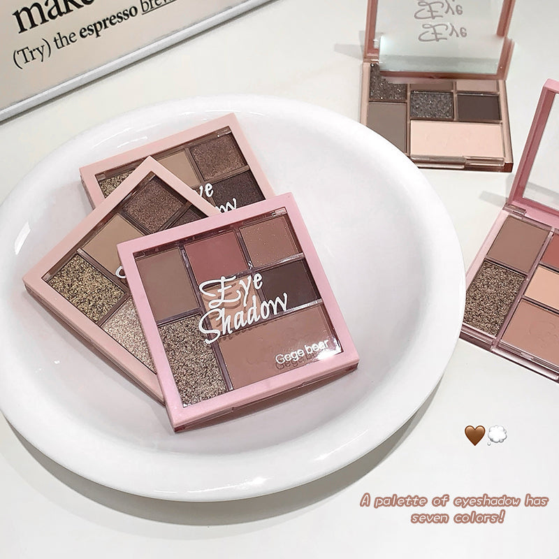 Makeup eyeshadow palette with multiple colors on a white plate