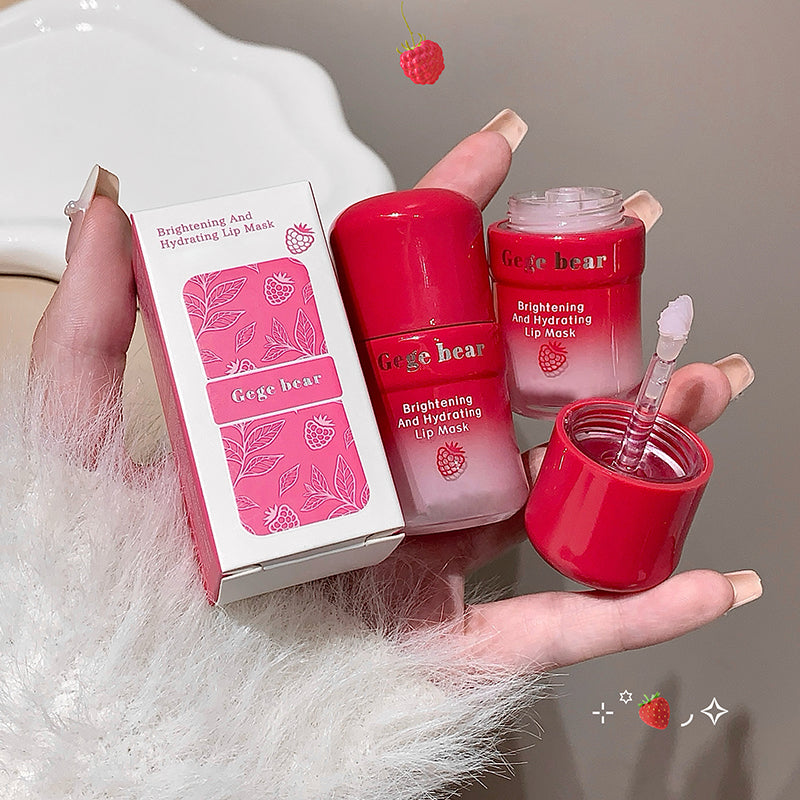 Red lip mask with packaging held by a hand on a neutral background