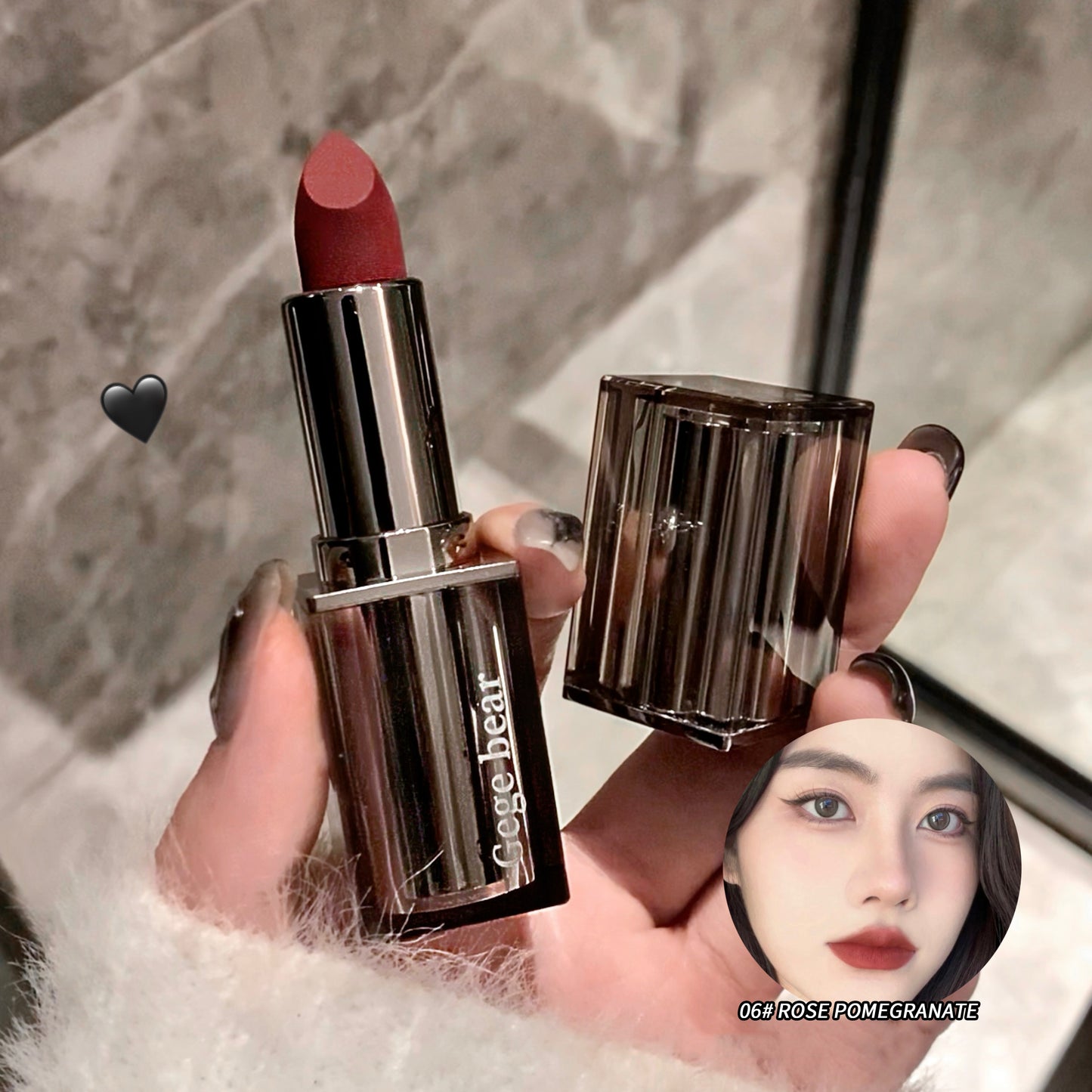 Lipstick with a visible brand name held by a hand against a neutral background