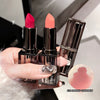 Three lipsticks held by a hand with a close-up of one shade on a white background.
