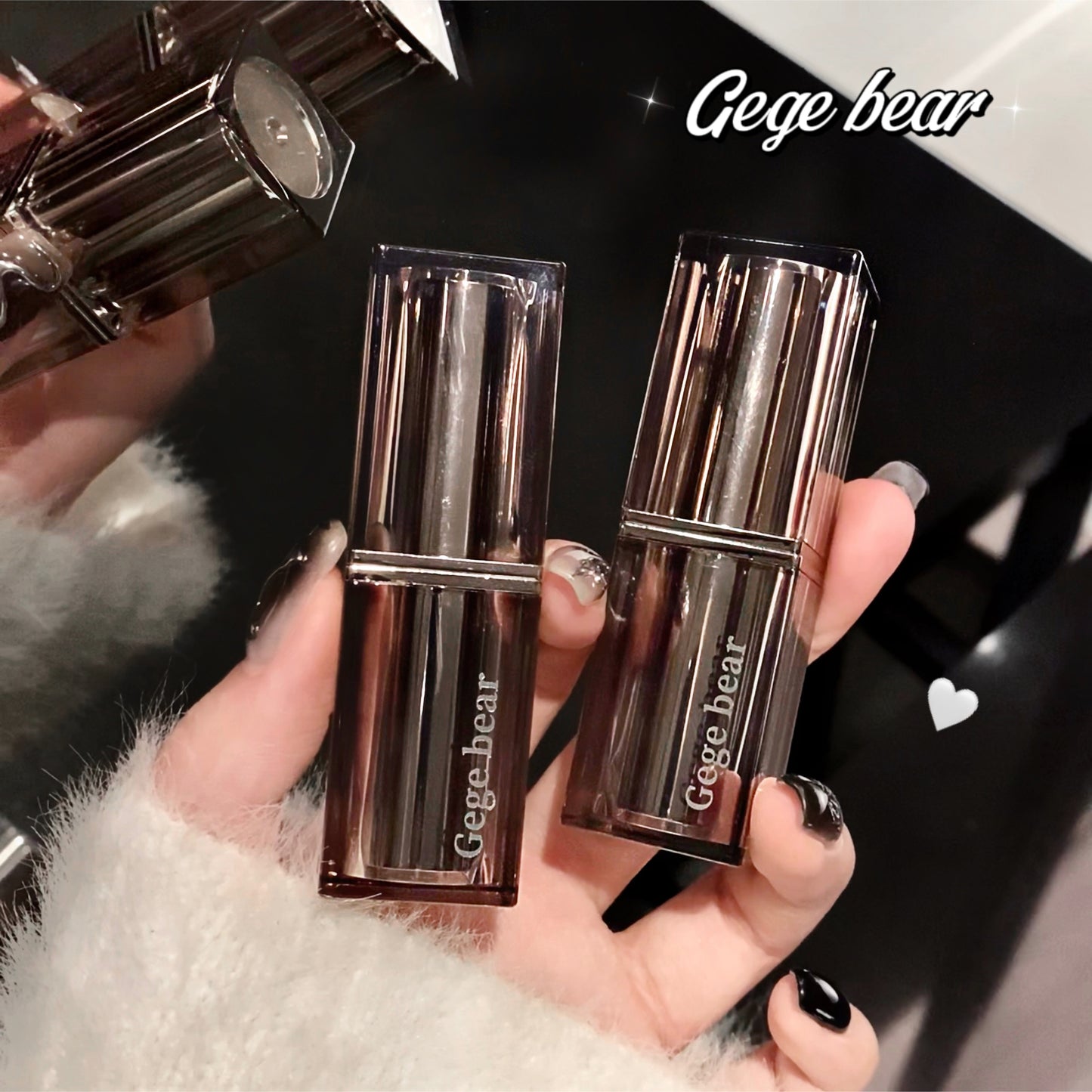 Two metallic lipstick cases held by a hand with 'Gage bear' branding.