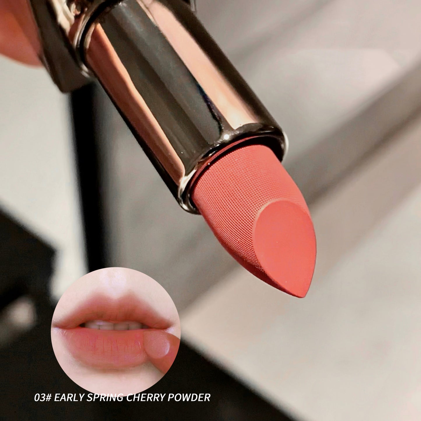 Close-up of a coral lipstick with a matching color swatch on lips, on a neutral background.
