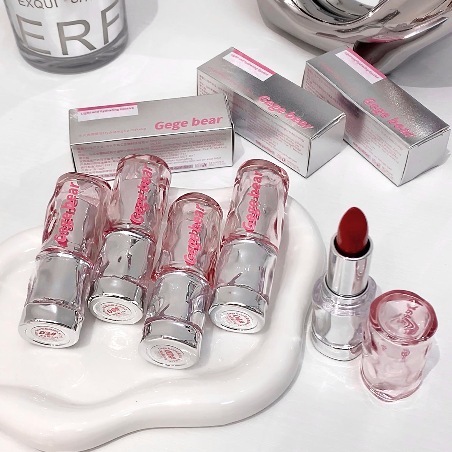 Set of Gege bear lip products including lipsticks and lip glosses on a white surface.