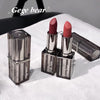Two lipsticks with clear casings on a white surface, branded 'Gege bear'.