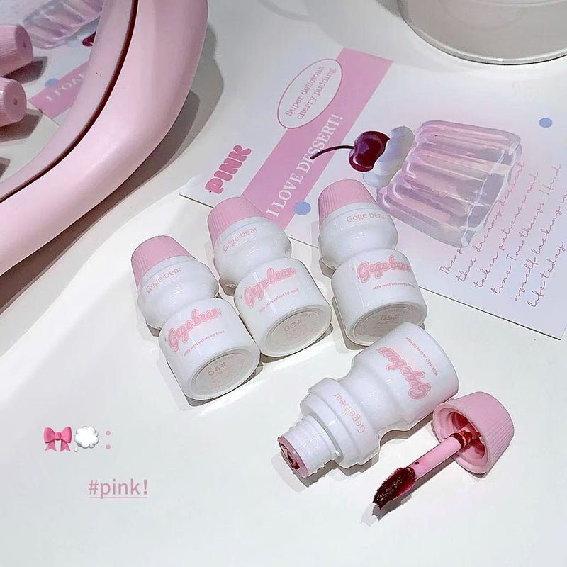 Set of white nail polish bottles with pink caps on a white surface with a pink mirror and text in the background.