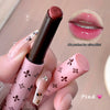Pink lipstick with decorative packaging held by a hand, close-up with lip swatch.