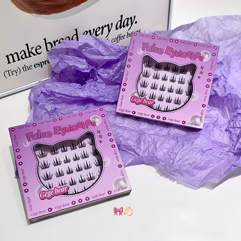 Two boxes of false eyelashes with a purple crumpled paper background