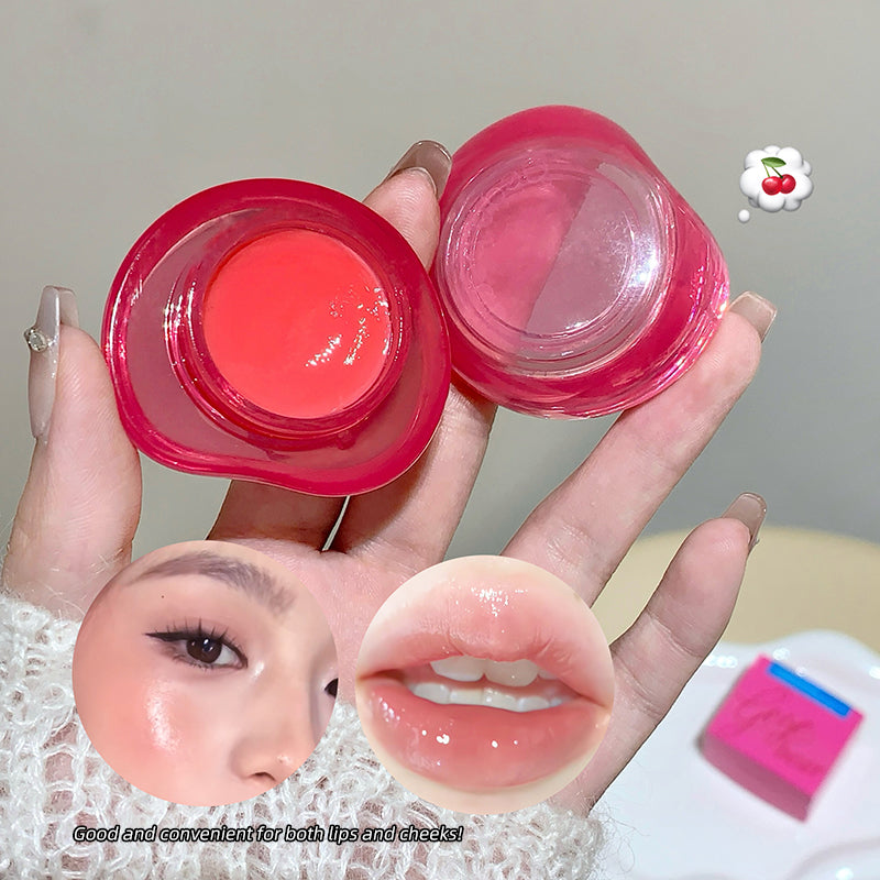Hand holding a pink lip balm container with close-up of lips and face.