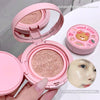 Pink cosmetic compact with a mirror, held by a hand, on a white background.