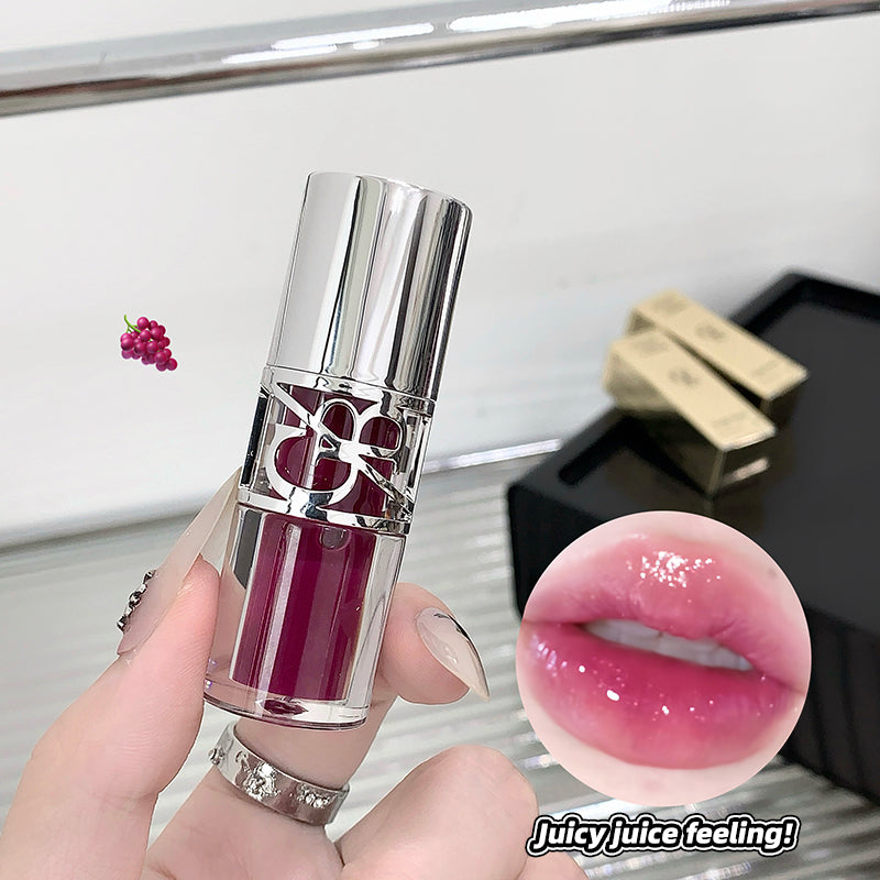 Lipstick held by a hand with a close-up of lips wearing the lipstick, and text 'Juicy juice feeling!' on a blurred background.