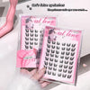 Cat-themed false eyelashes packaging with pink and white design on a white surface.
