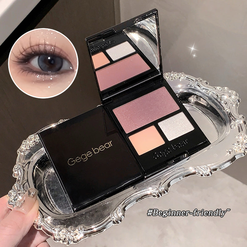 Makeup palette with eyeshadow shades on a decorative tray, featuring the brand 'Gege bear'.