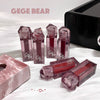 Gege Bear lip gloss bottles on a white background