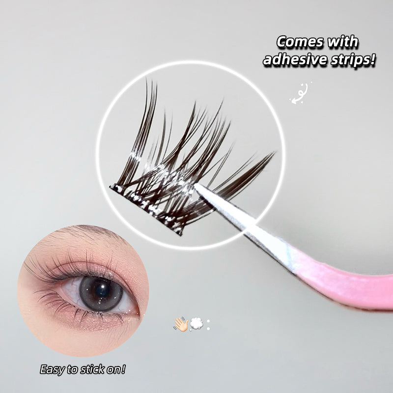 False eyelashes with adhesive strips and application tool on a gray background
