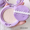Makeup compact with purple lid and matching sponge, held by a hand.