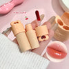 Lip gloss set with applicator and close-up of lips wearing the product on a pink background.