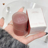 Pink lip balm with 'Gege Bear' branding held in a hand, next to its packaging.
