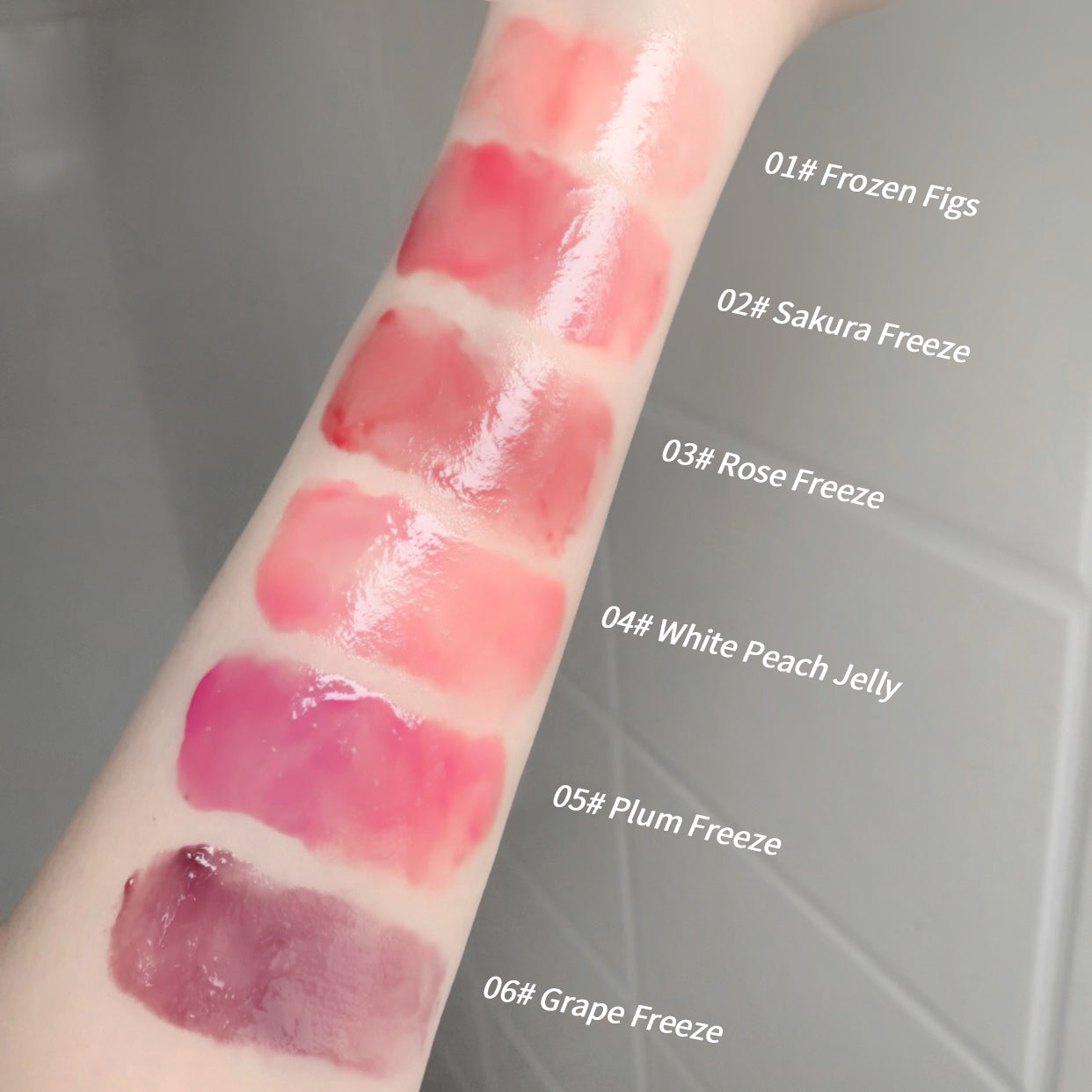 Lipstick swatches on a person's arm with color names labeled.