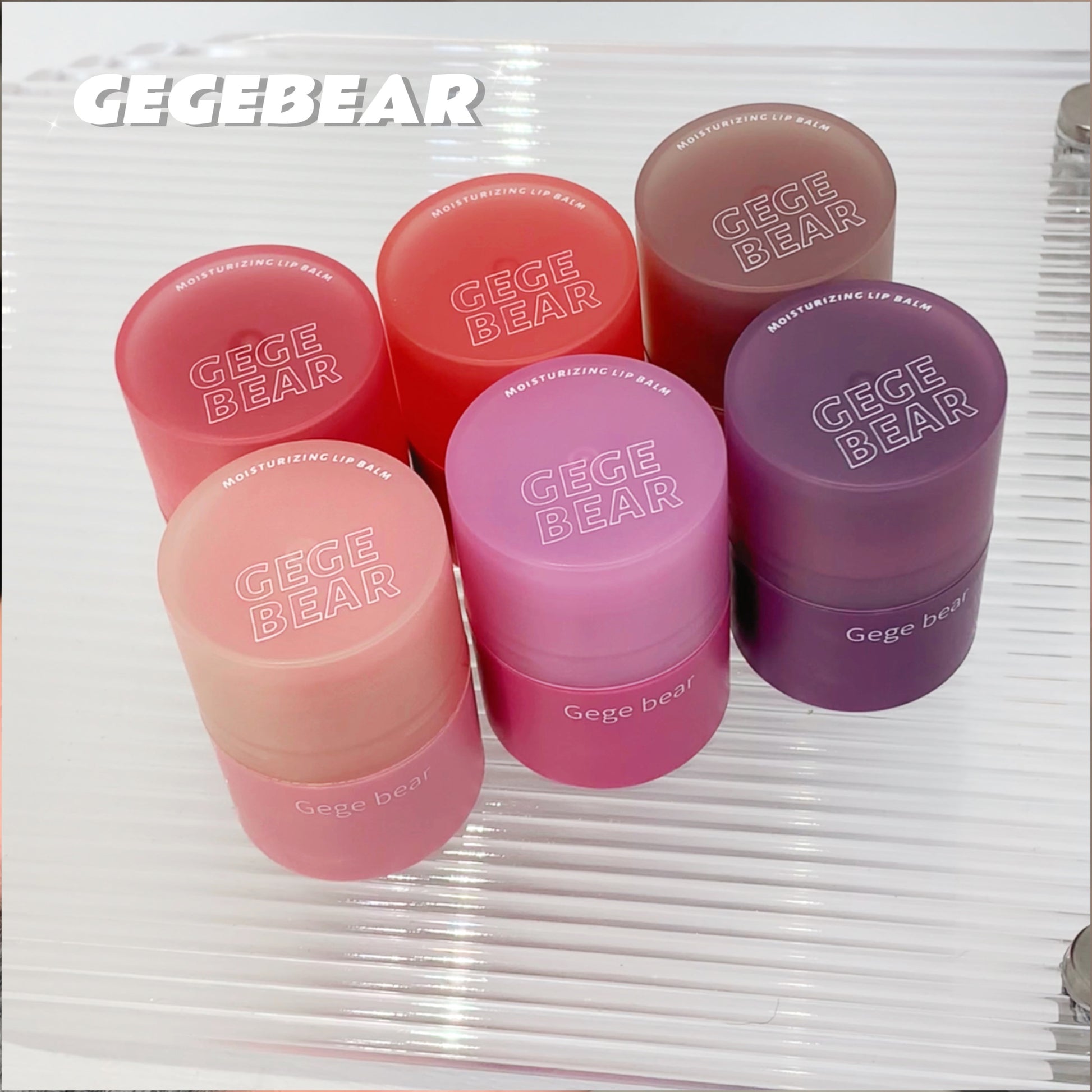 Set of Gege Bear lip balm containers on a white background