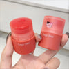 Two small red containers with 'Gege bear' branding held in a hand against a neutral background.