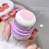 Pink makeup sponge with 'Gege bear' branding held by a hand.