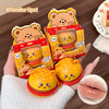 Cute bear-shaped lip balm with packaging held by a hand, close-up of lips shown.