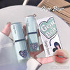 Lip gloss with heart design and 'Gege Bear' branding, held by a hand.
