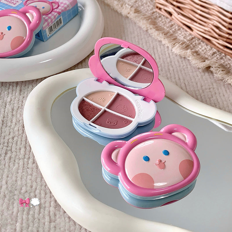 Compact makeup set with bear design on a textured surface