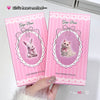 Two pink 'Gege Bear' lip gloss packages held by a hand on a white background.