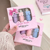Pink packaging of 'Gege bear' air fog feeling lip mud box held by a person.