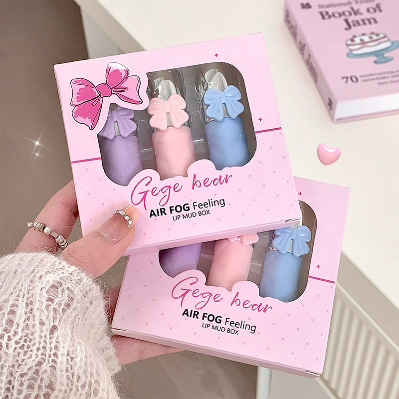 Pink packaging of 'Gege bear' air fog feeling lip mud box held by a person.