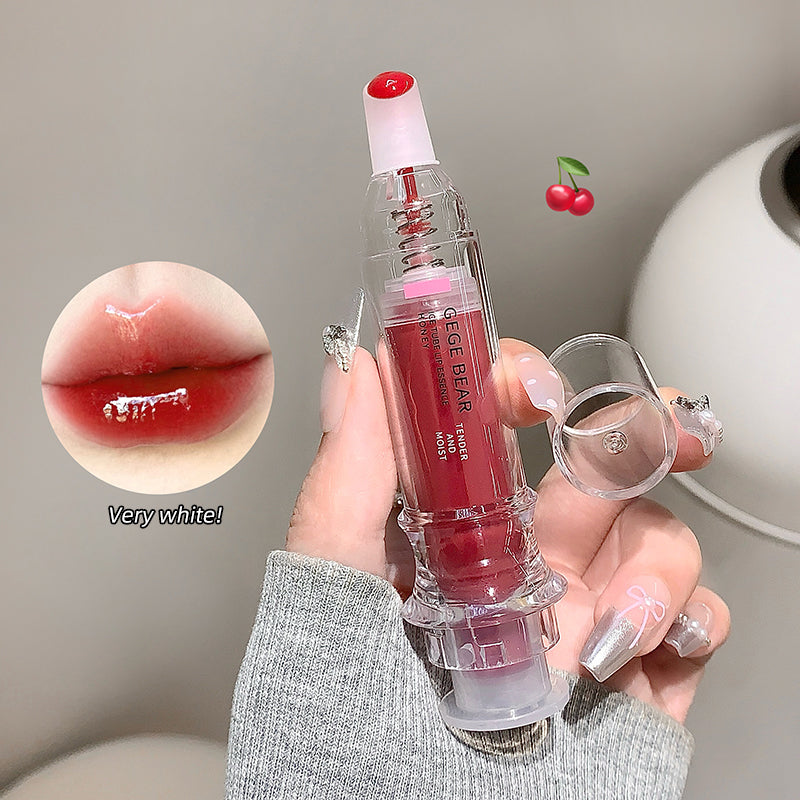 Lip gloss held by a hand with close-up of lip color and cherry icons.