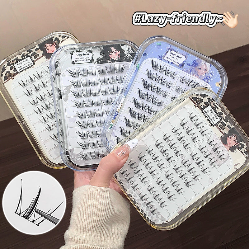 Set of false eyelashes in clear containers with a hand holding one container, on a wooden surface.