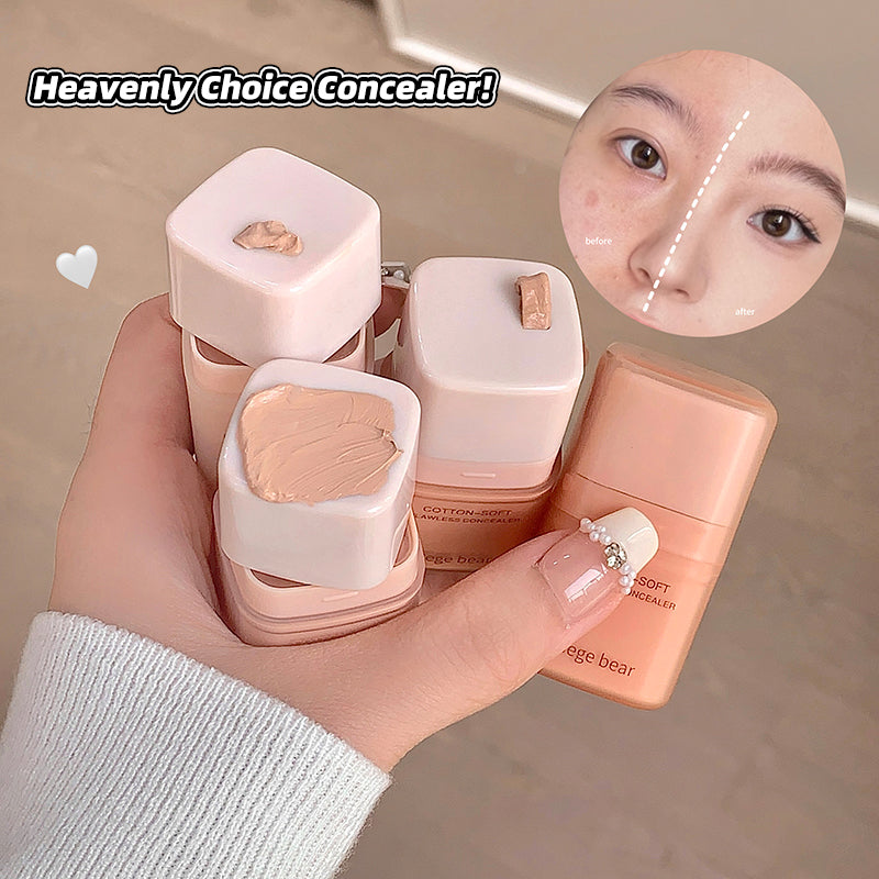 Hand holding a set of concealer products with a close-up of a person applying concealer.
