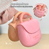 Pink and beige bag-shaped case with lip glosses inside, held by a hand.