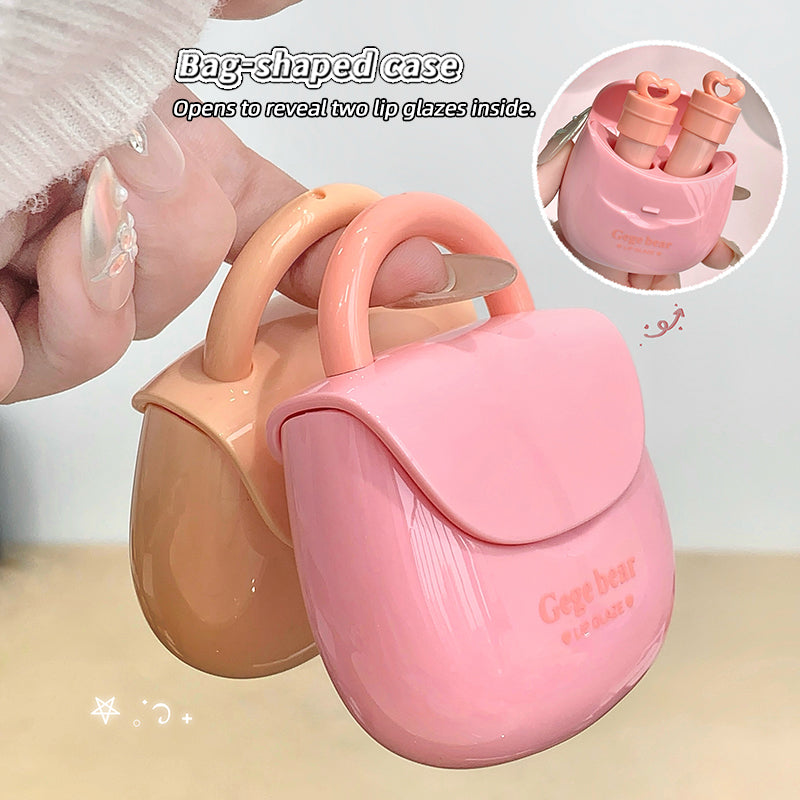 Pink and beige bag-shaped case with lip glosses inside, held by a hand.