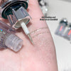 Close-up of glitter being applied to skin with a small applicator.