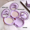 Four open purple makeup compacts with different colored powders on a light surface.
