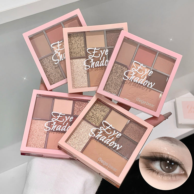 Set of four eye shadow palettes with pink cases on a light gray background, one palette open showing shades.