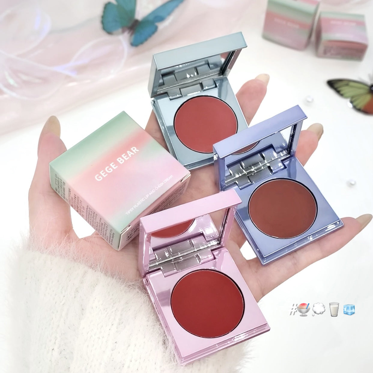 Three compact blushes in different colors held by a hand with a soft background.