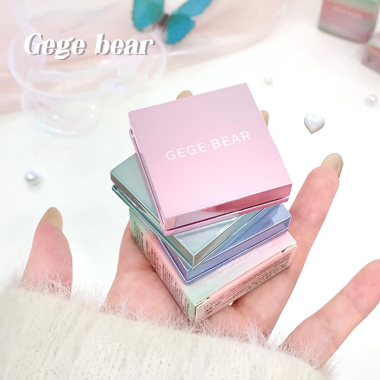 Stack of small, pastel-colored boxes with 'Gege Bear' branding held in a hand.