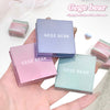 Three GEGE BEAR lip and cheek creams in different colors held by a hand on a light background.