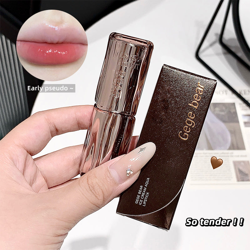 Lipstick and case held by a hand with close-up of lipstick color on lips.