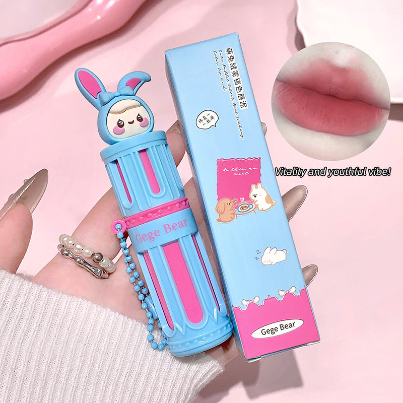 Lip balm with cartoon bear design and packaging on a pink background