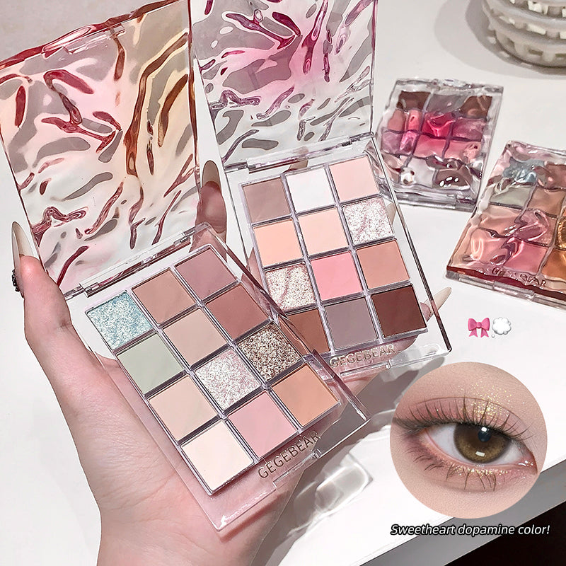Makeup palette with colorful eyeshadows held by a hand, with an inset of an eye wearing the makeup.