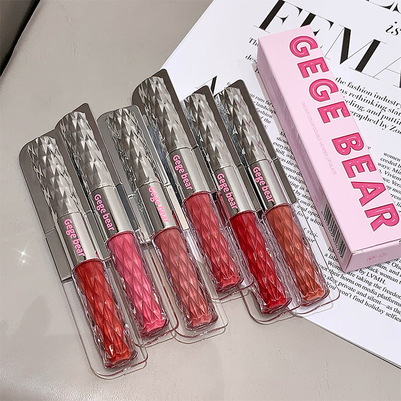 Set of GEGE BEAR lip glosses in clear packaging on a magazine background