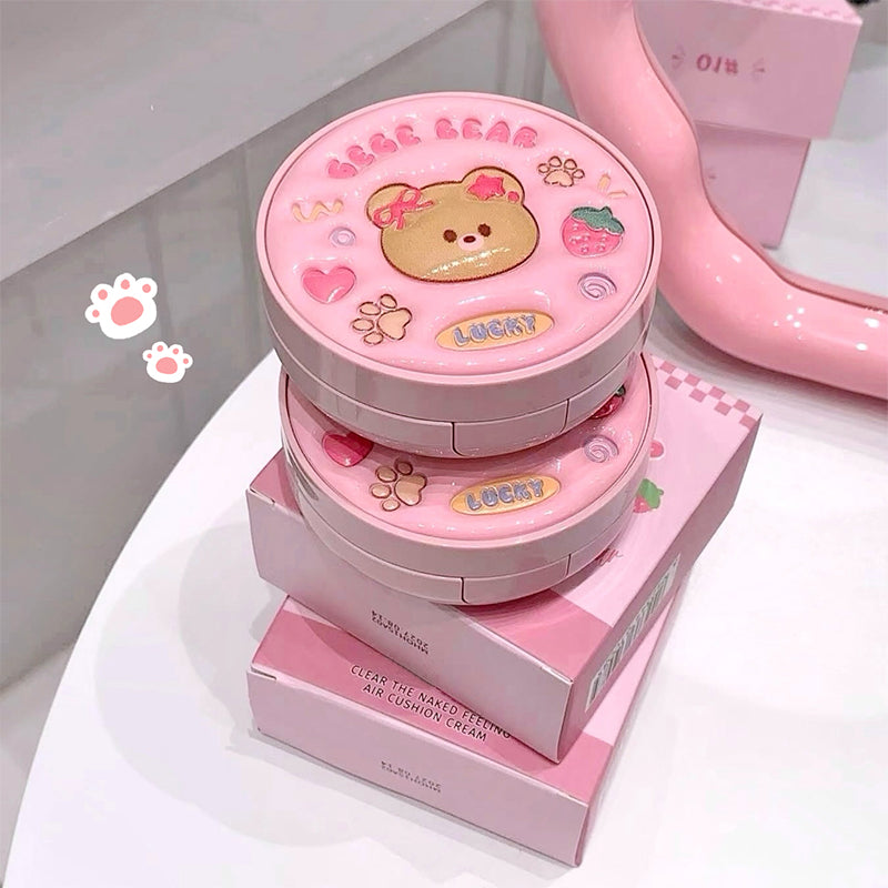 Pink cosmetic product with bear design on a white background