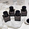 Black cylindrical containers with 'Gege bear' branding on a white textured surface.